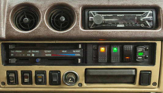 Image of dash pocket panel installed with carling switches into an FJ60 dash panel using carling switches