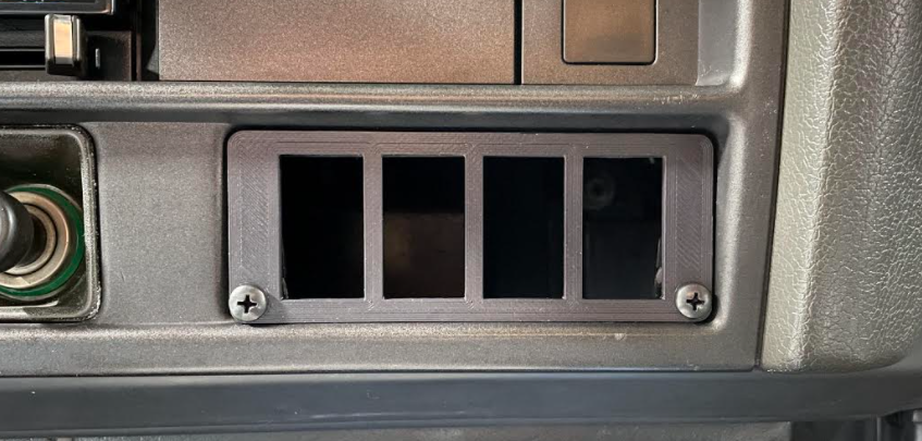 Close up of FJ62 ash tray carling insert installed into dash bezel interior