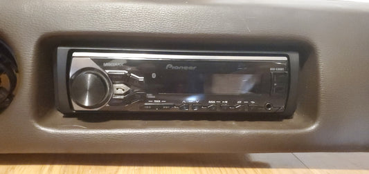 aftermarket single din Radio installed into FJ60 Bracket